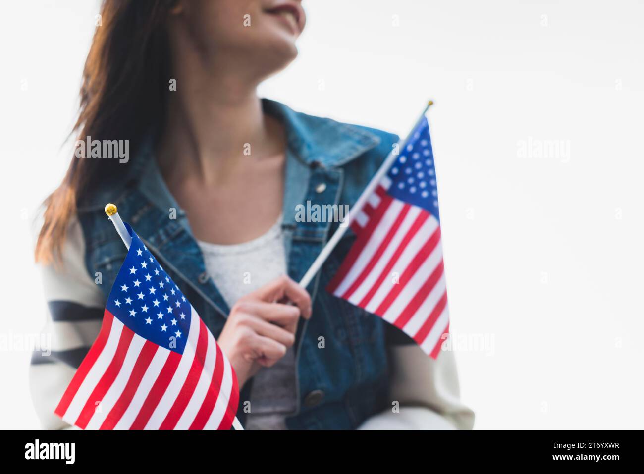 Young smiling lady holding american flags Stock Photo