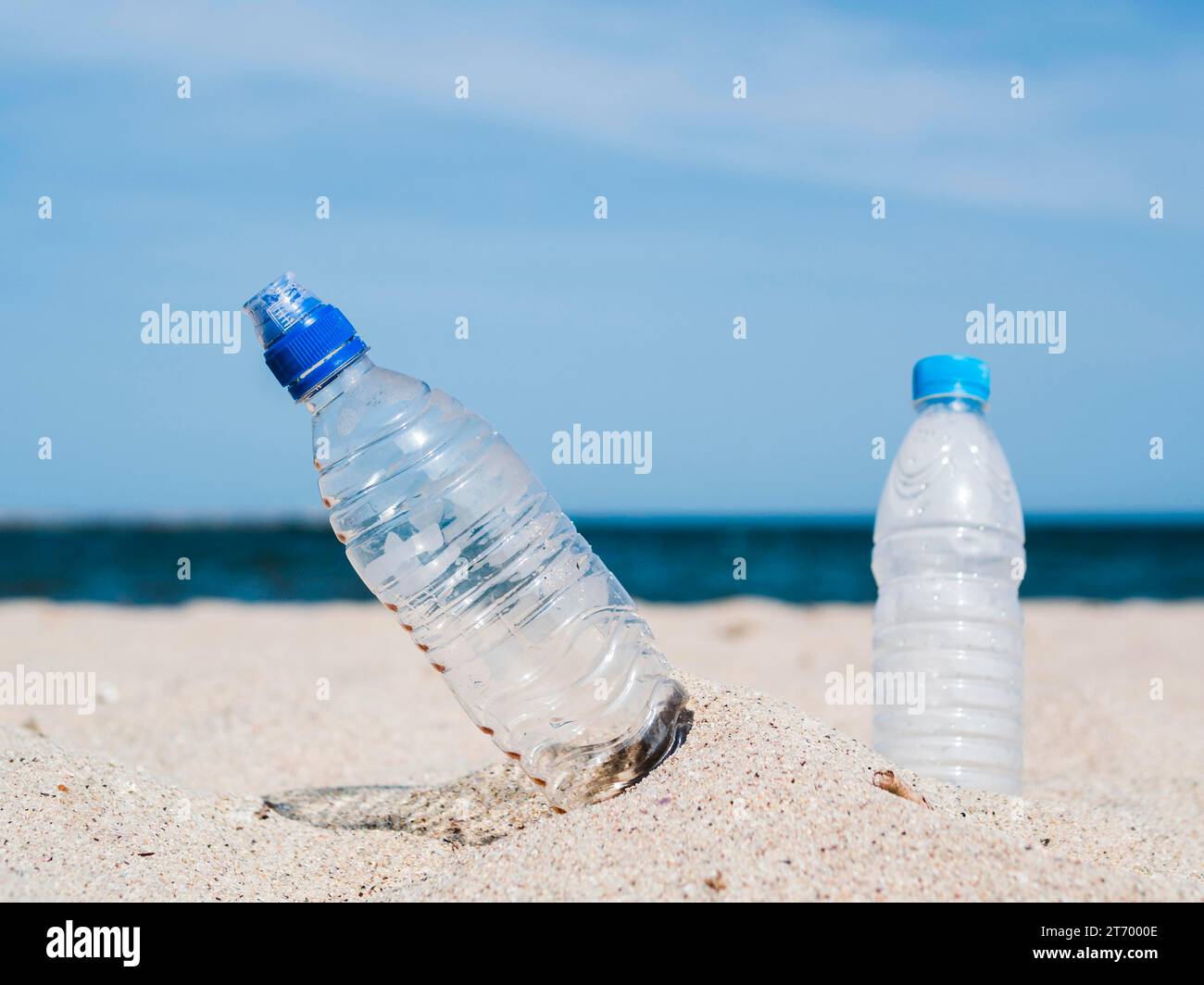 Close up plastic water bottles stuck sand beach Stock Photo Alamy