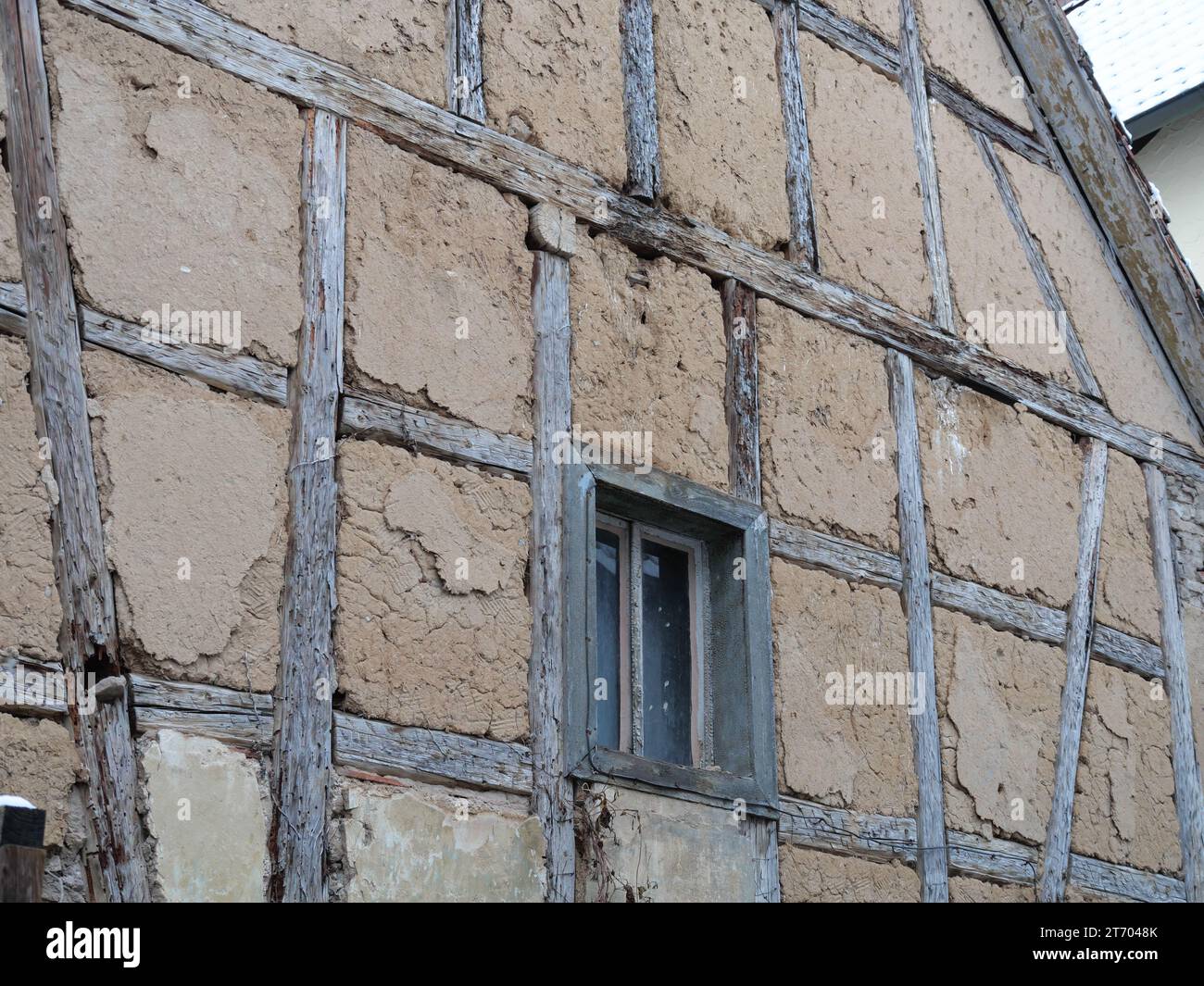 Detail of an old half-timbered house with beams, windows and adobe walls Stock Photo