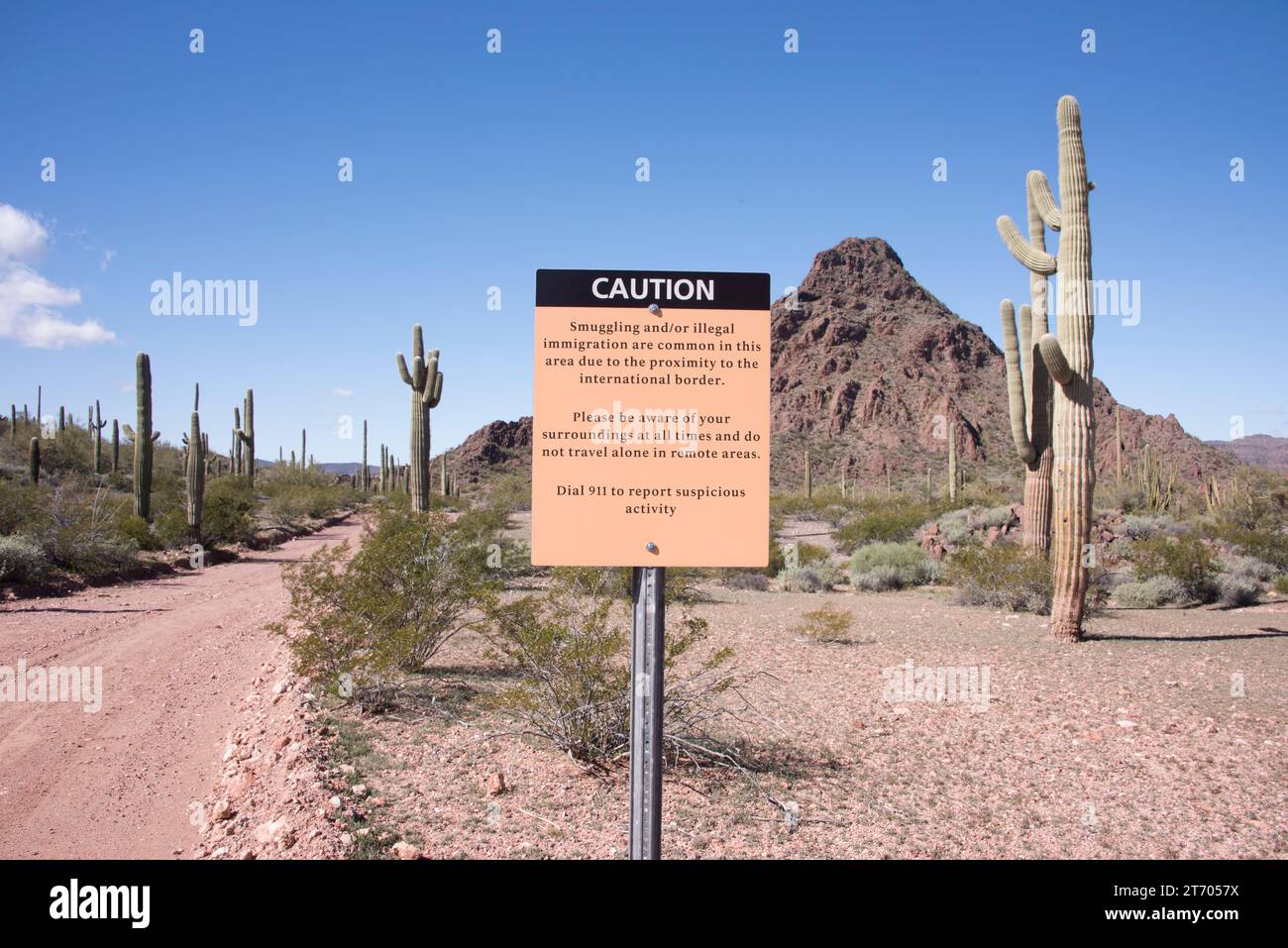 Sign along international border with Mexico, warning of dangers of smuggling and more, Organ Pipe Cactus National Monument, Ajo, Arizona, USA Stock Photo