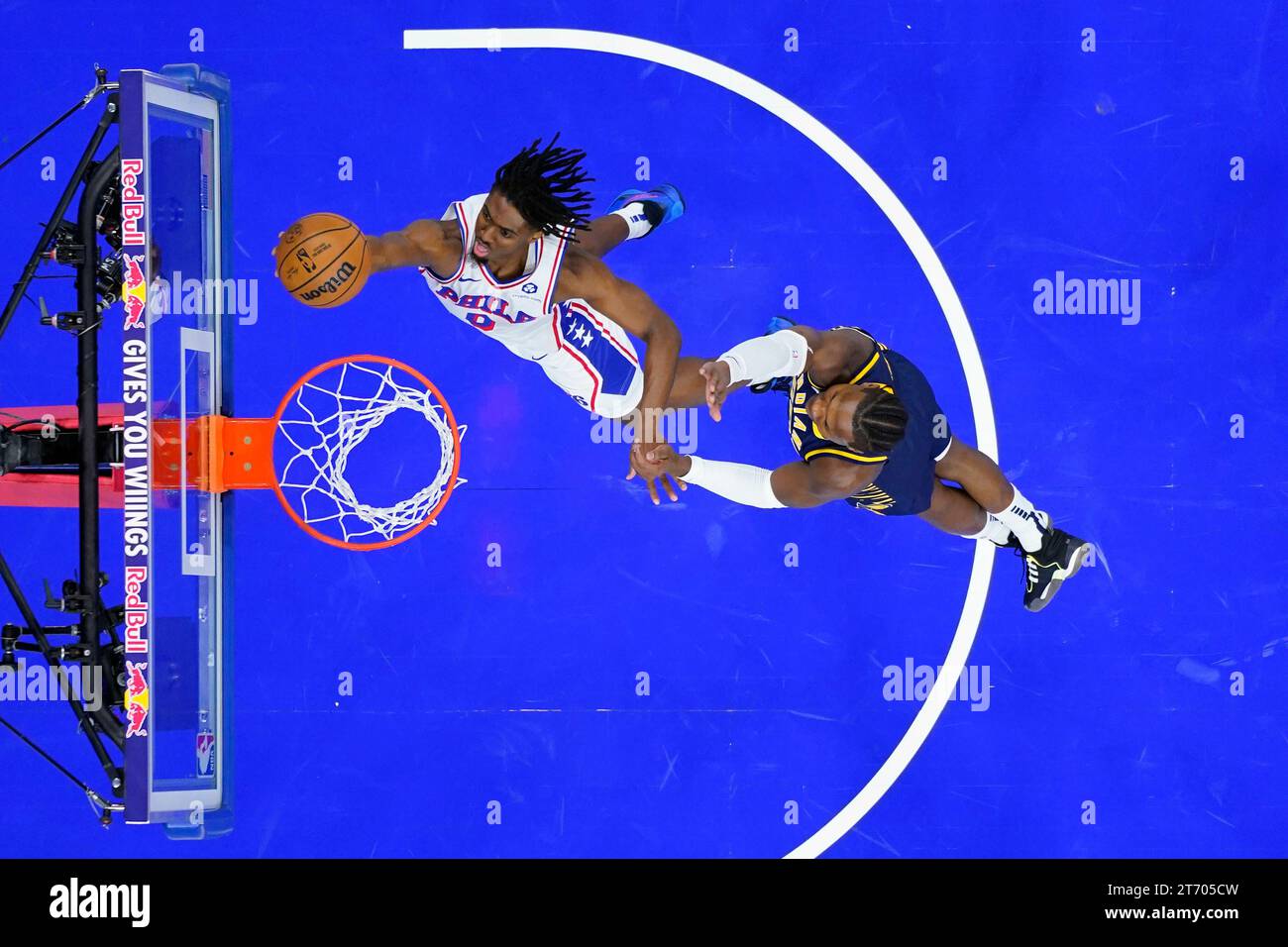 Philadelphia 76ers' Tyrese Maxey, left, goes up for a shot past Indiana ...