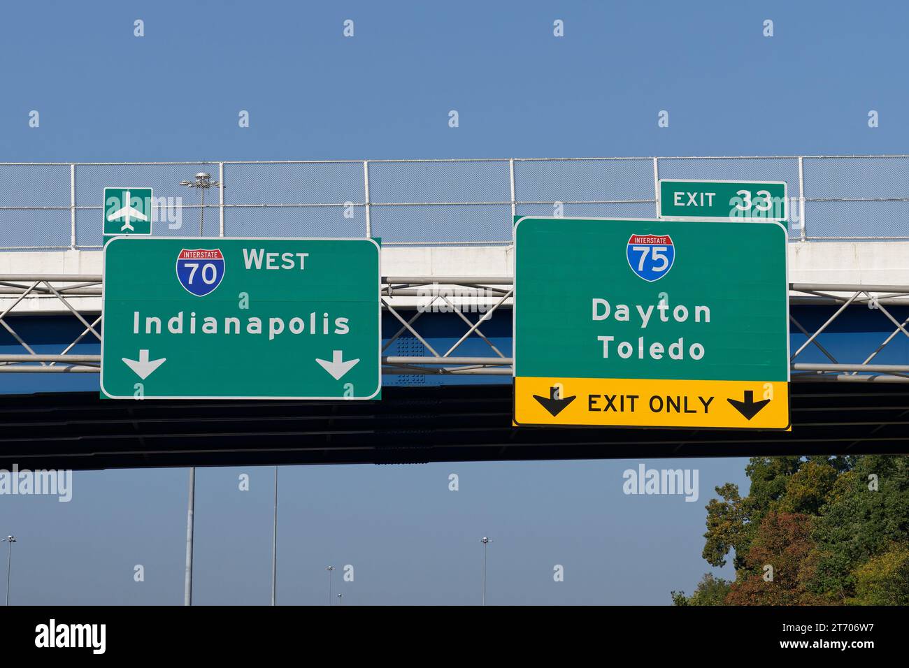 Signs on Interstate 70 for continuing west toward Indianapolis and the Dayton International Airport and exit 33 for Interstate 75 toward Dayton and To Stock Photo