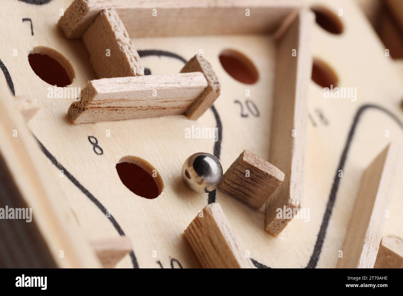 Wooden toy maze with metal ball, closeup Stock Photo