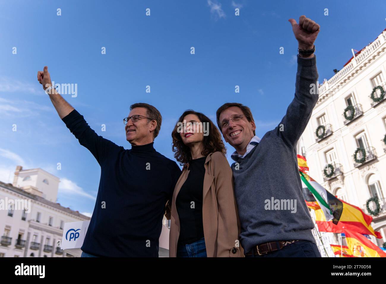 The PP leader Alberto Nunez Feijoo (L), the President of the Autonomous Government of Madrid, Isabel Diaz Ayuso (C), and the Mayor of Madrid Jose Luis Martinez Almeida (R) are seen during the demonstration in Puerta del Sol. Demonstration organized by the Popular Party against the pact between the PSOE(Spanish Socialist Workers' Party) and Junts(Catalan political party's ) signed last November 9 in Brussels to invest the acting Prime Minister and Socialist candidate for re-election, Pedro Sanchez. The pact with Junts includes a possible amnesty law for those convicted of the ‘process'. Stock Photo