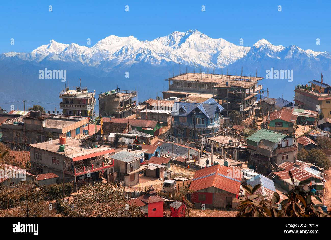 Scenic mountain village town near Tinchuley hill station with view of the Kanchenjunga Himalaya range at Darjeeling, India Stock Photo