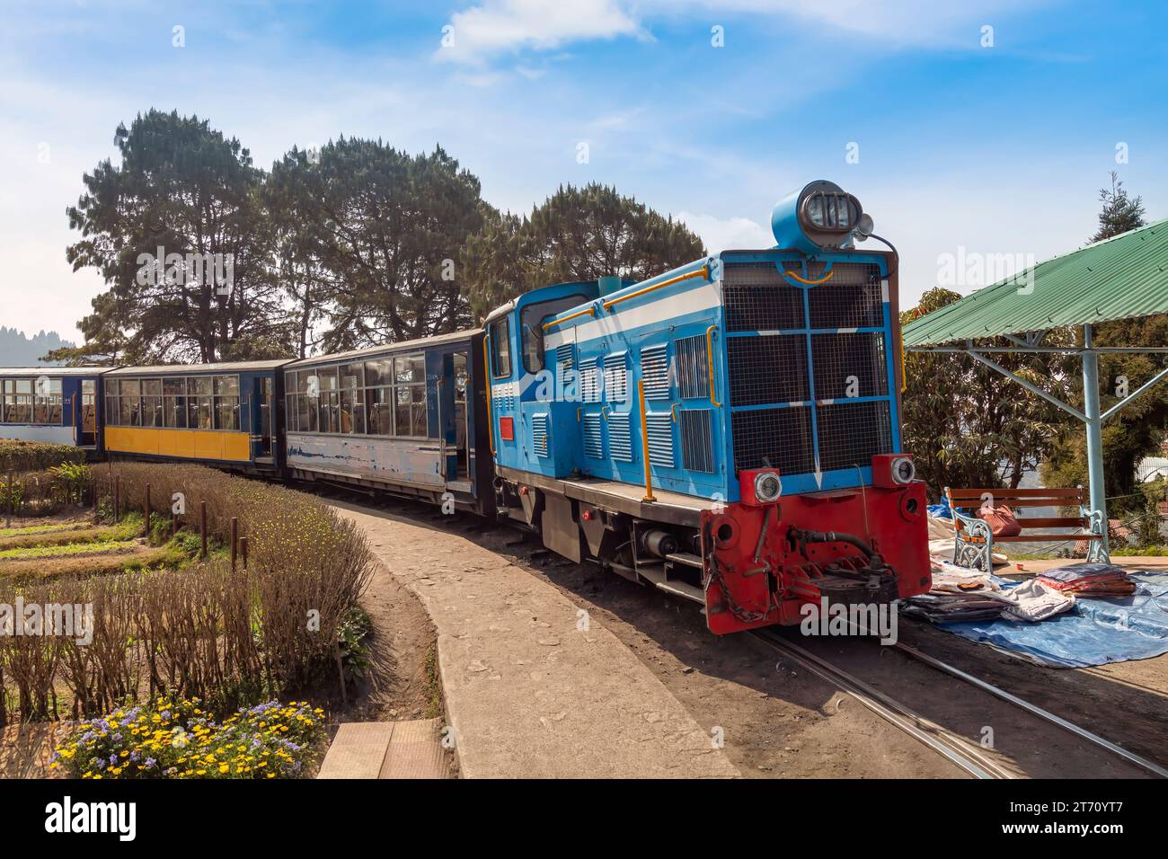 Famous Toy train of the Darjeeling Himalayan railway with view of tourists at Batasia loop in West Bengal, India Stock Photo