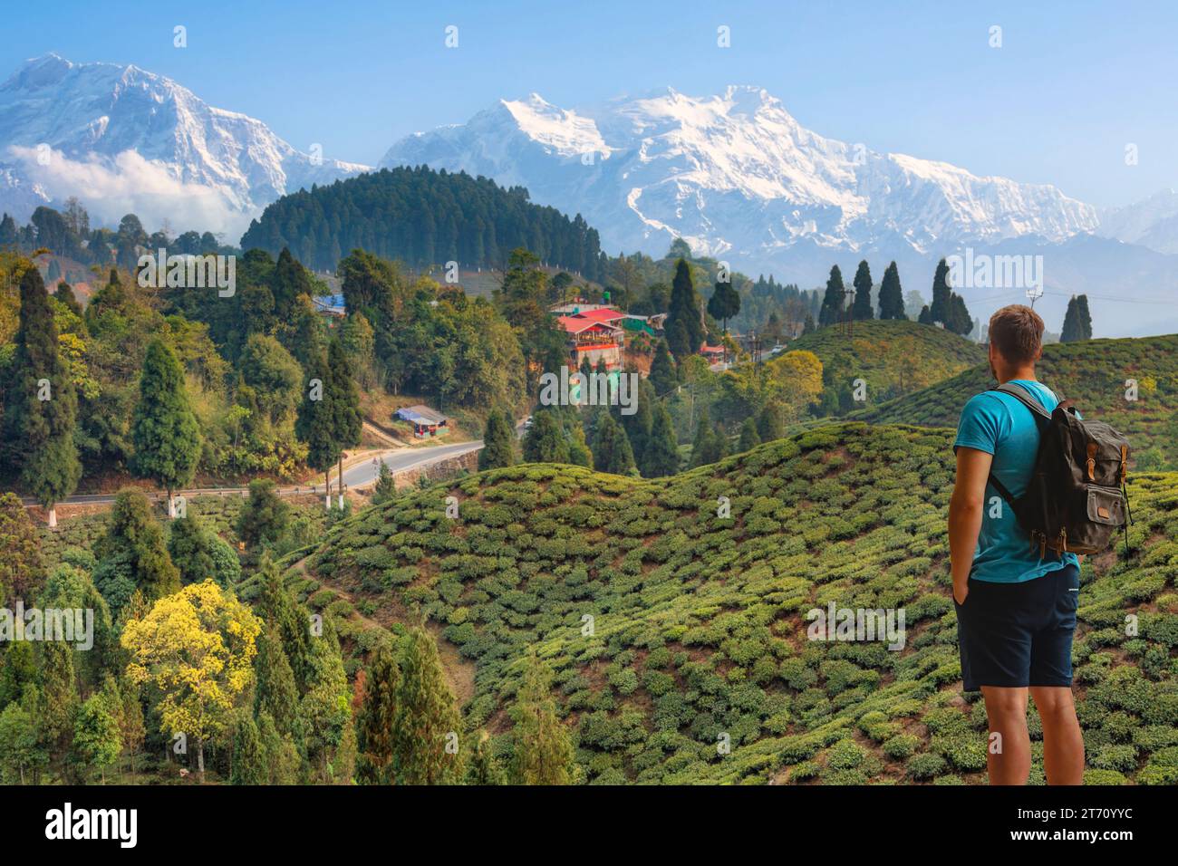 Male tourist enjoys view of the scenic landscape with the majestic Kanchenjunga Himalaya range at the popular hill station of Darjeeling, India. Stock Photo