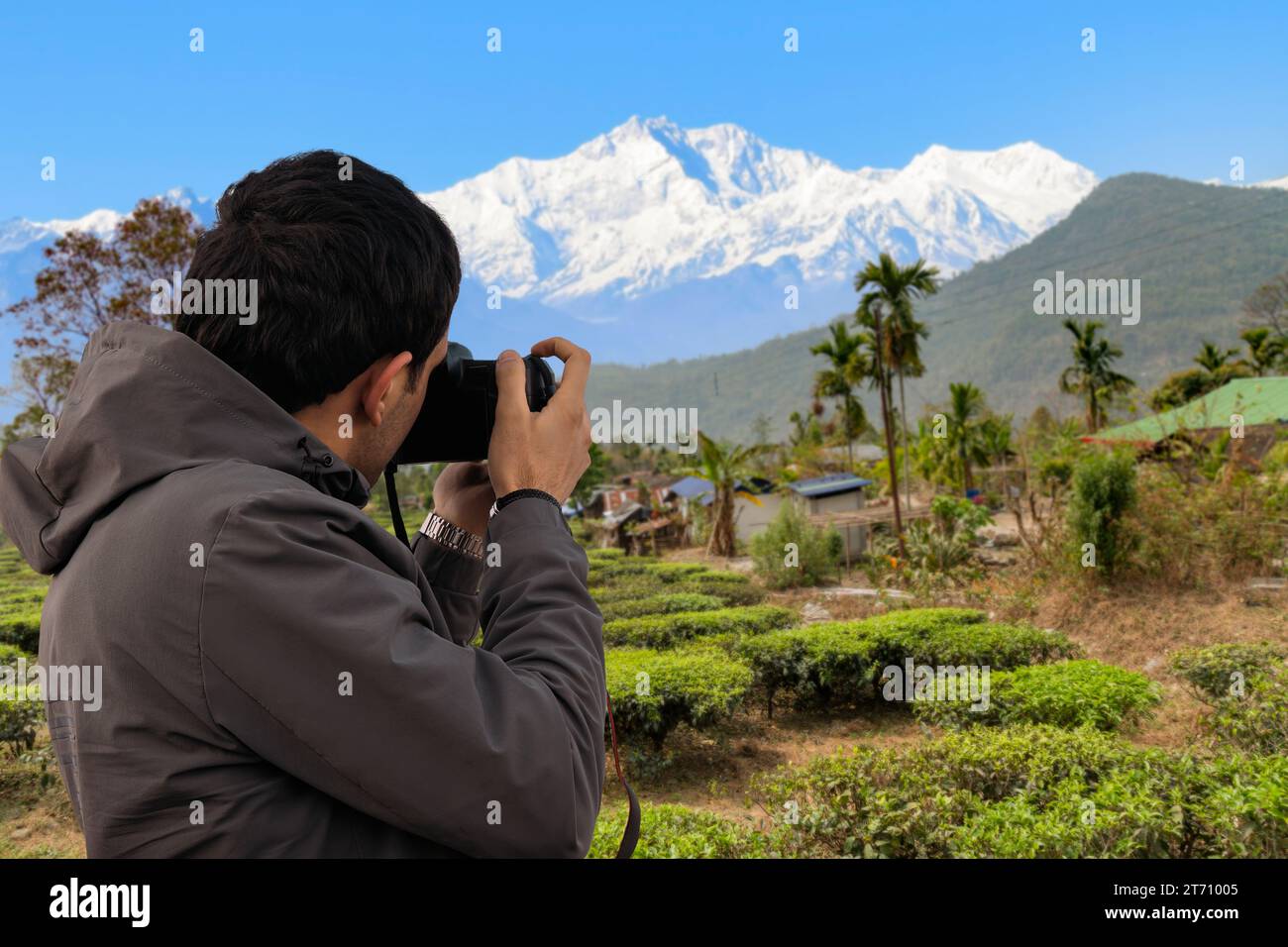 Kanchenjunga Himalaya mountain range as seen from Golitar view point with view of vehicles, tourists and shops at Darjeeling, India Stock Photo