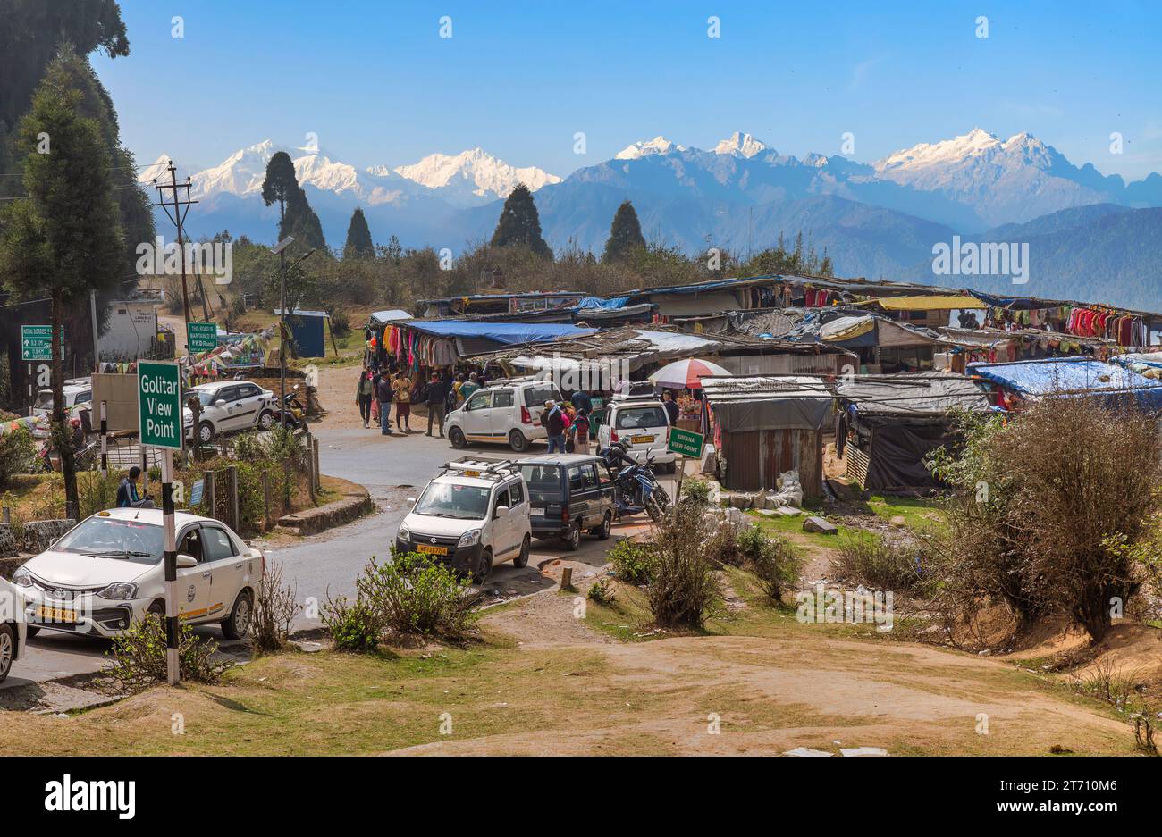 Kanchenjunga Himalaya mountain range as seen from Golitar view point with view of vehicles, tourists and shops at Darjeeling, India Stock Photo