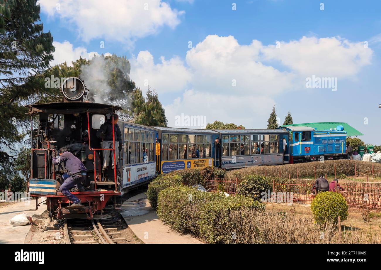 Darjeeling Toy train of the Himalayan railway with view of tourists at Batasia loop in West Bengal, India Stock Photo