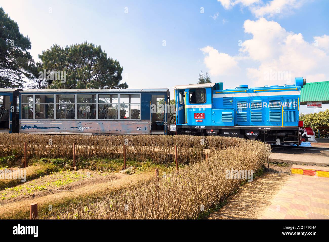 Darjeeling Toy train of the Himalayan railway with view of tourists at Batasia loop in West Bengal, India Stock Photo