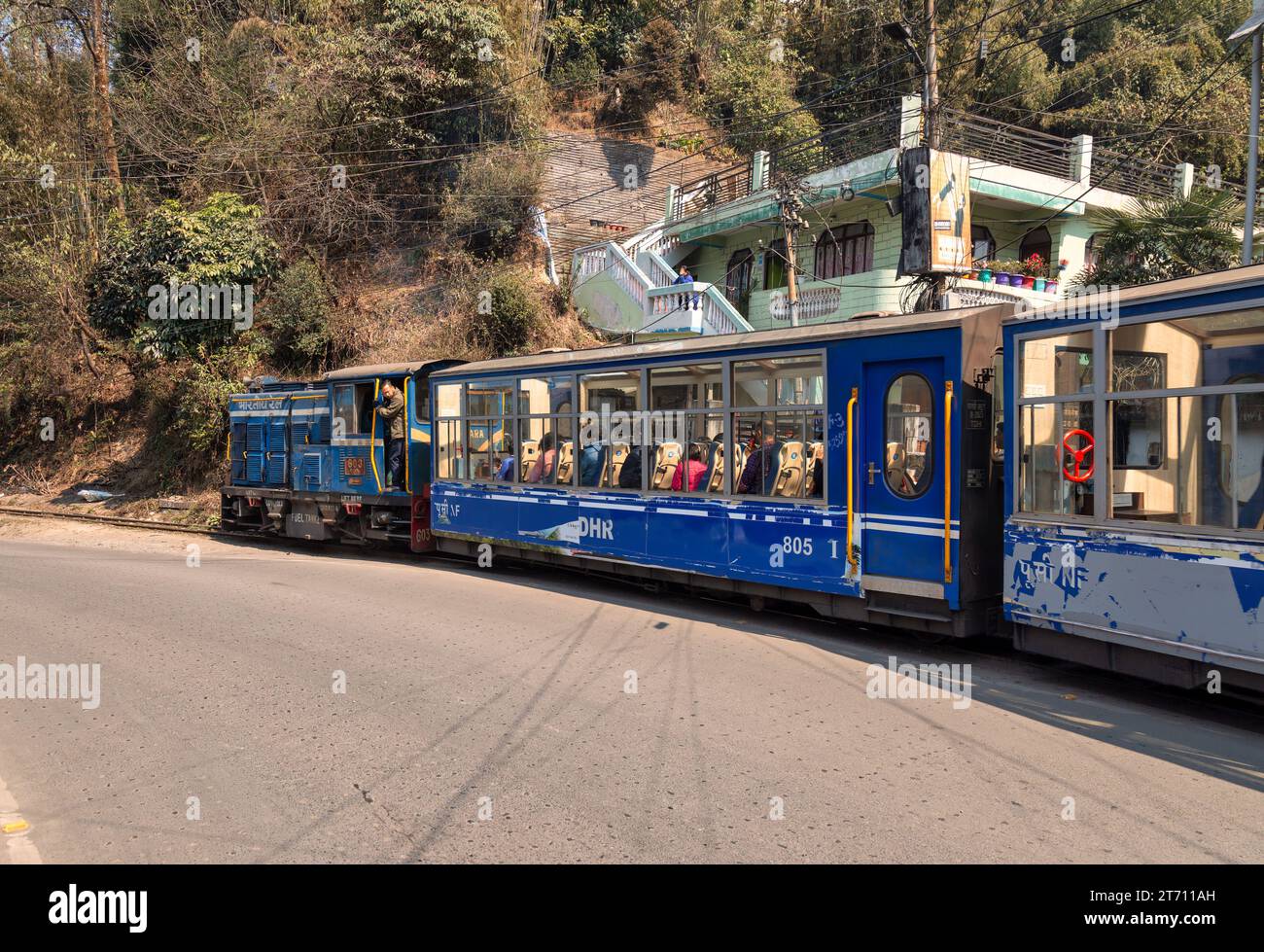Toy train of the Darjeeling Himalayan railway with view of tourists at Batasia loop in West Bengal, India Stock Photo