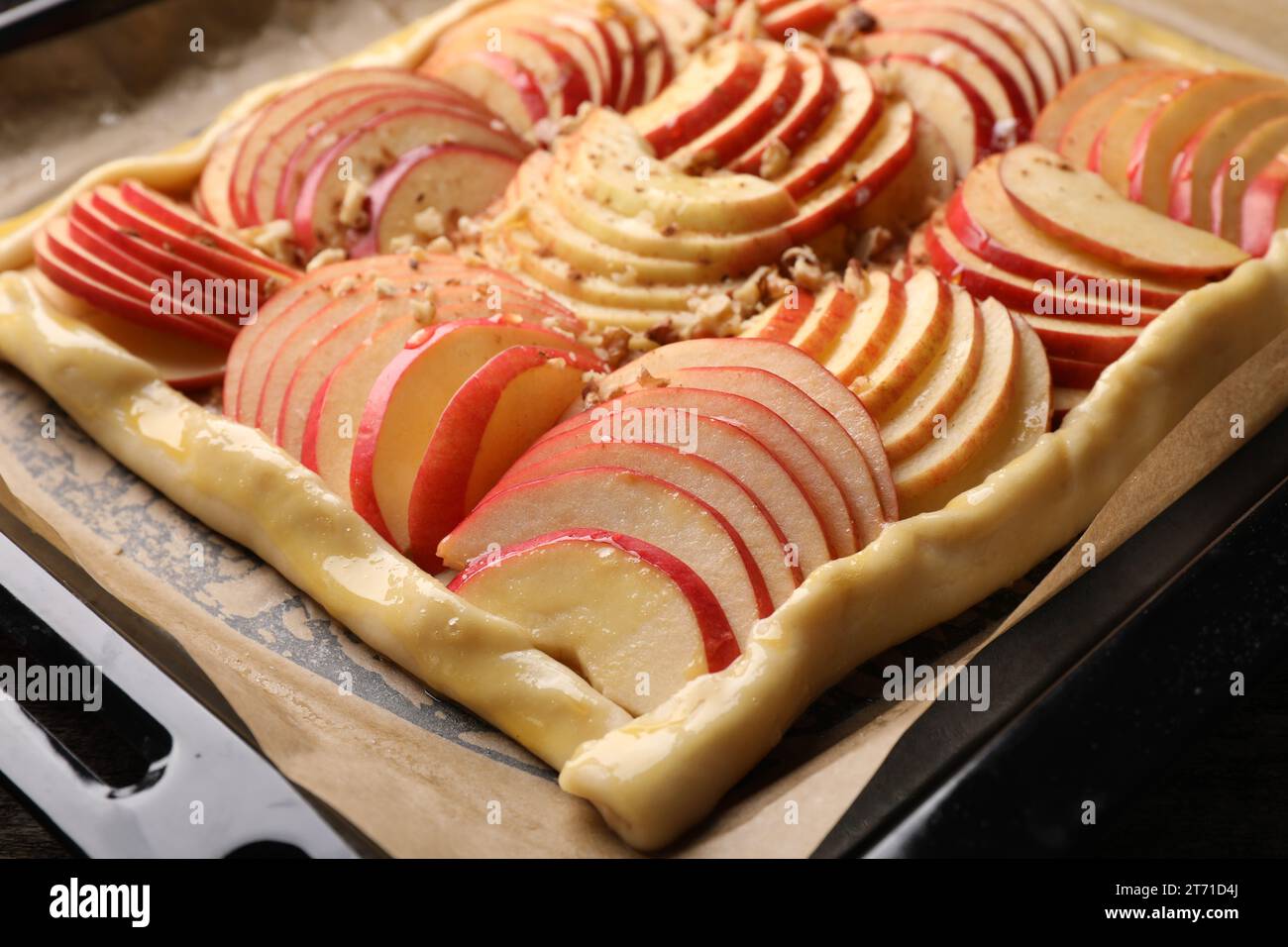 Uncooked apple galette with nuts on baking tray, closeup Stock Photo