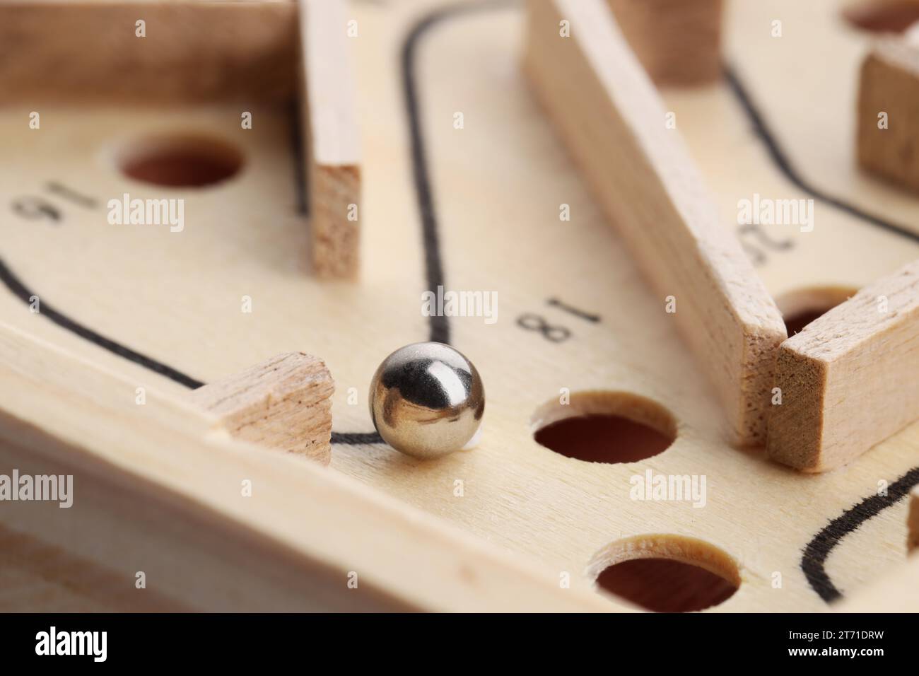 Wooden toy maze with metal ball, closeup Stock Photo