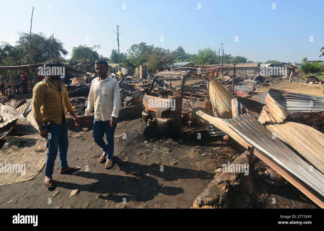 dimapur-india-13th-nov-2023-residents-walk-pass-by-their-charred