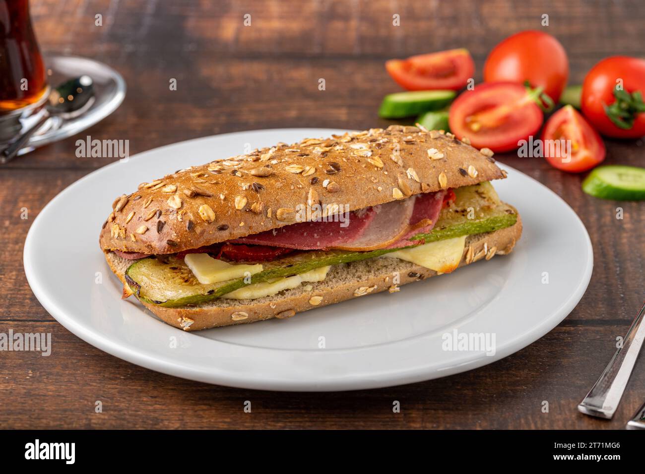 Vegetable and ham sandwich with tea on wooden table Stock Photo