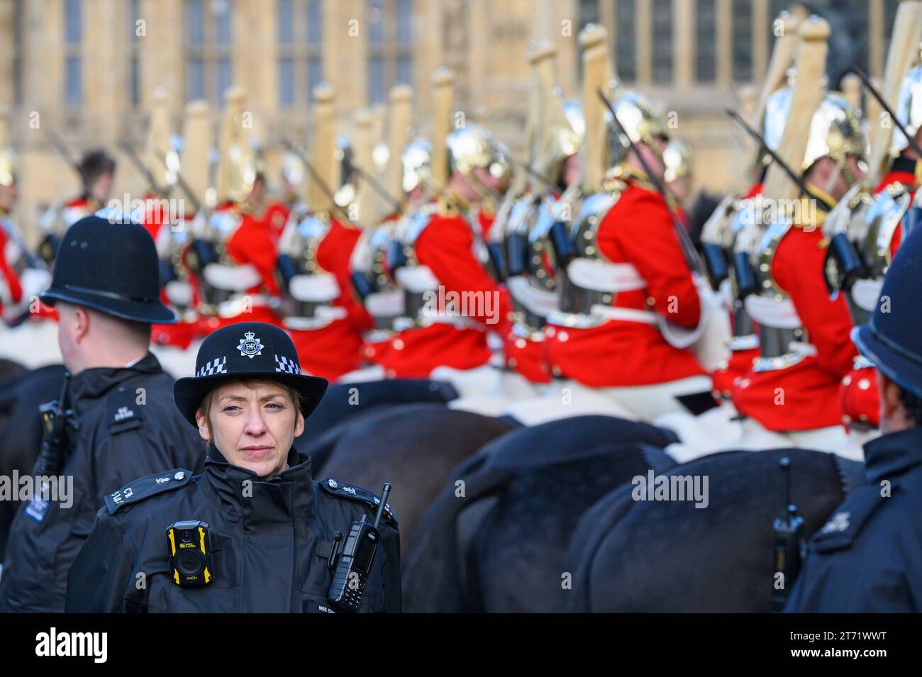 Police officers with members of the Household Cavalry waiting in Westminster during King Charles III first State Opening of Parliament as king. 7th No Stock Photo