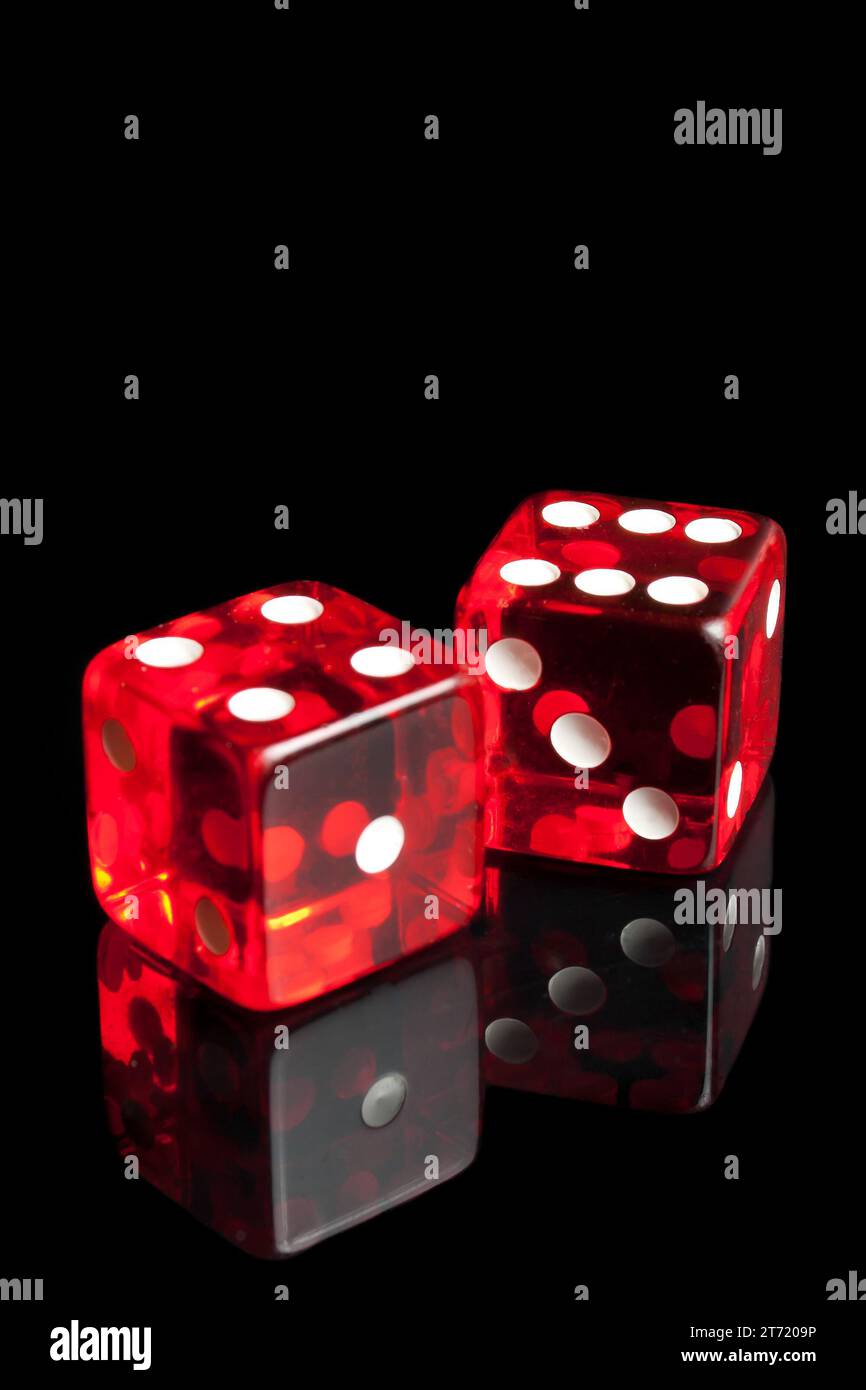 detail of red dice on transparent black background Stock Photo