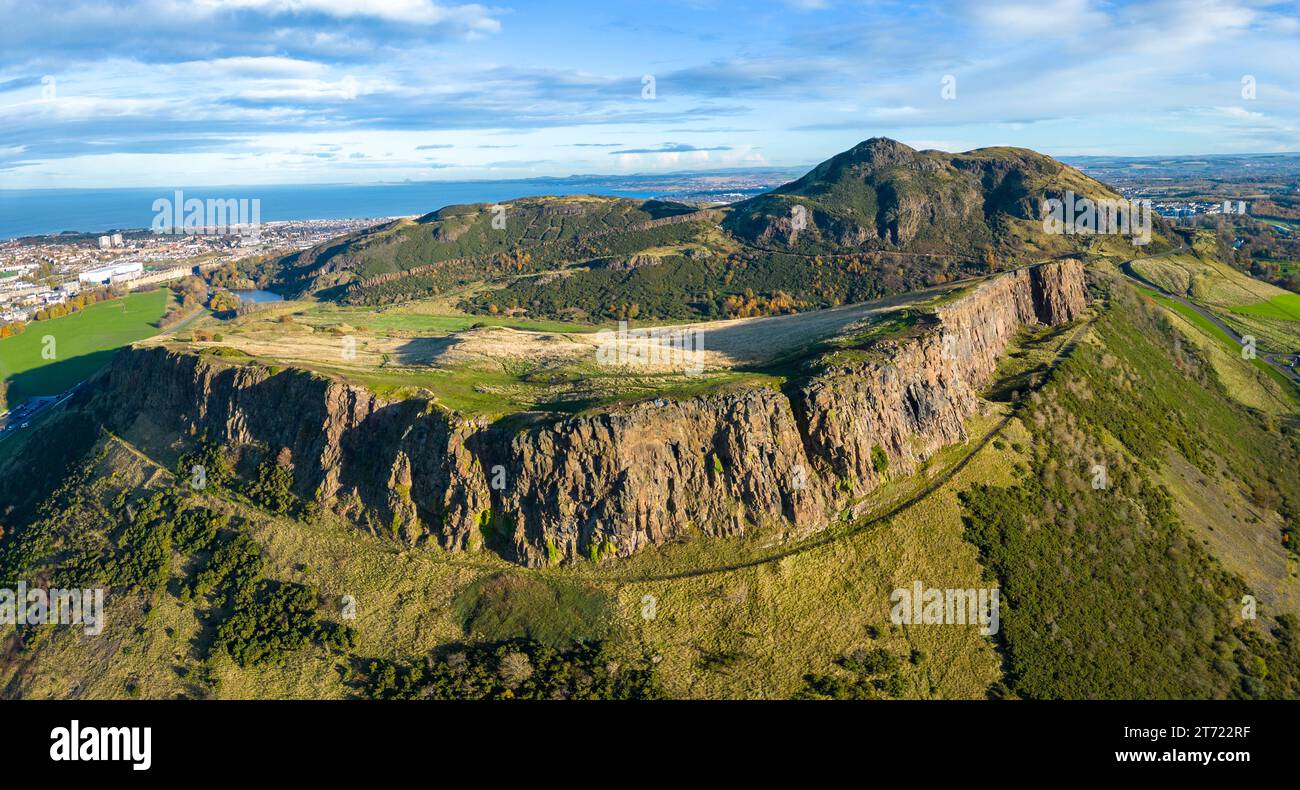 Aerial view of Salisbury Crags with Arthur’s Seat to rear in autumn  in Holyrood Park, Edinburgh, Scotland, UK Stock Photo