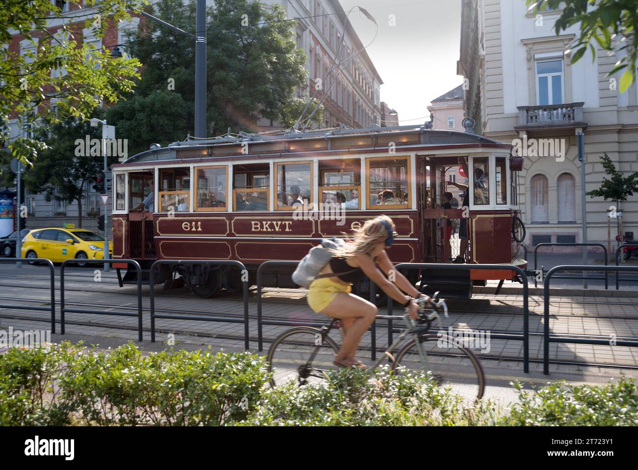 Vintage tram and bicyclist on a street Stock Photo