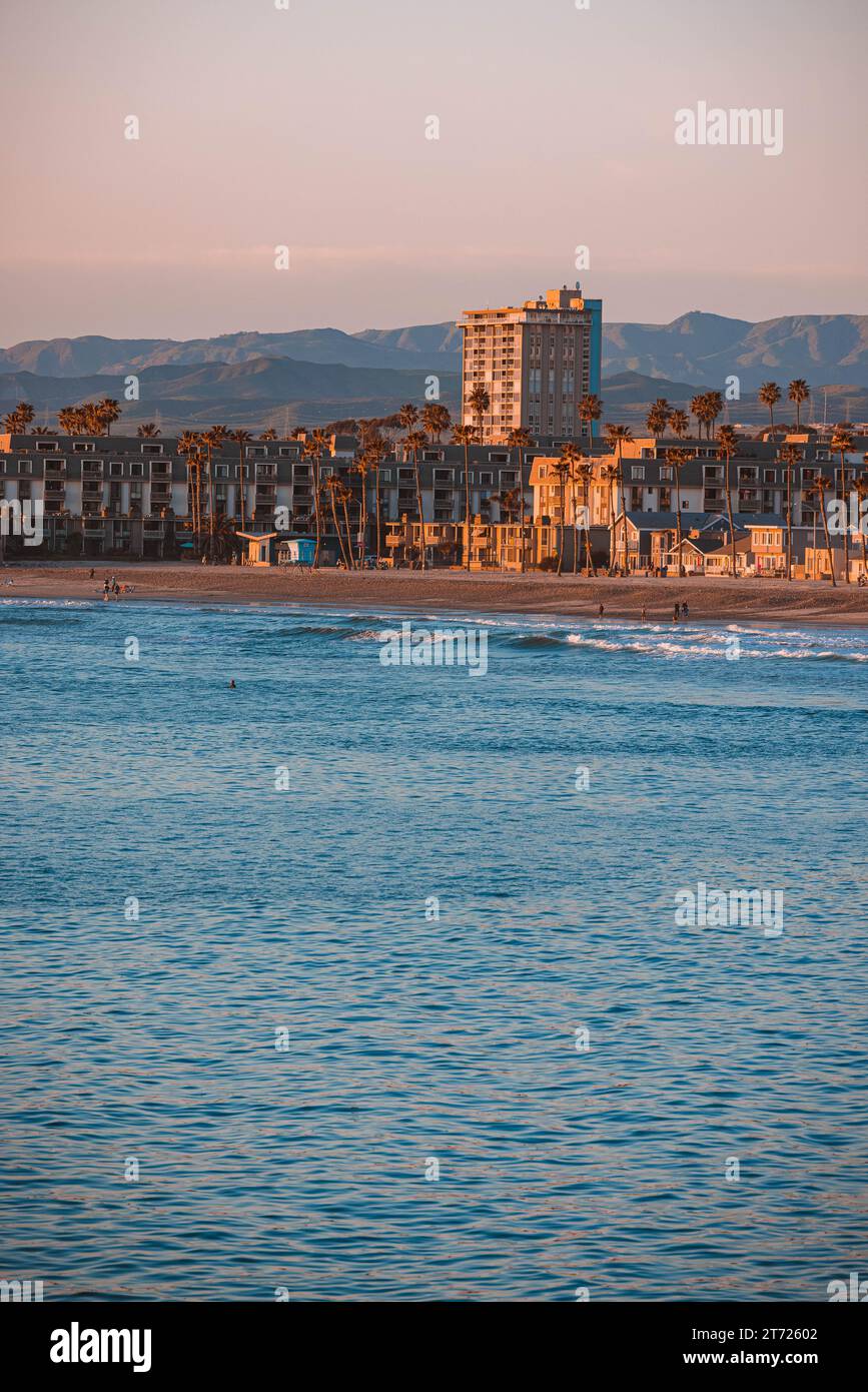 A vibrant city skyline illuminated at sunset, with tall buildings Stock ...