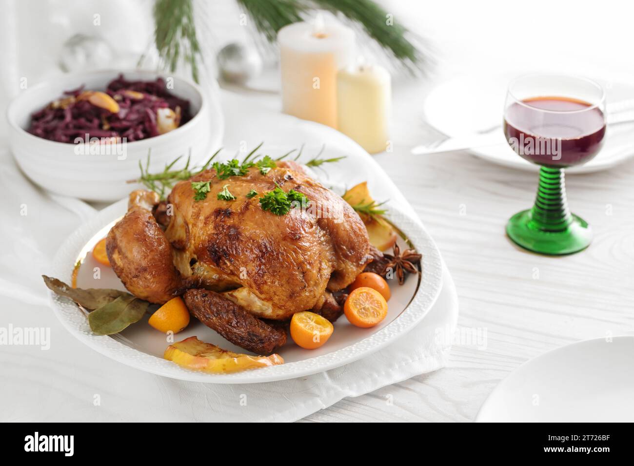 Festive poultry dinner, roast chicken with fruits and herbs, served ...