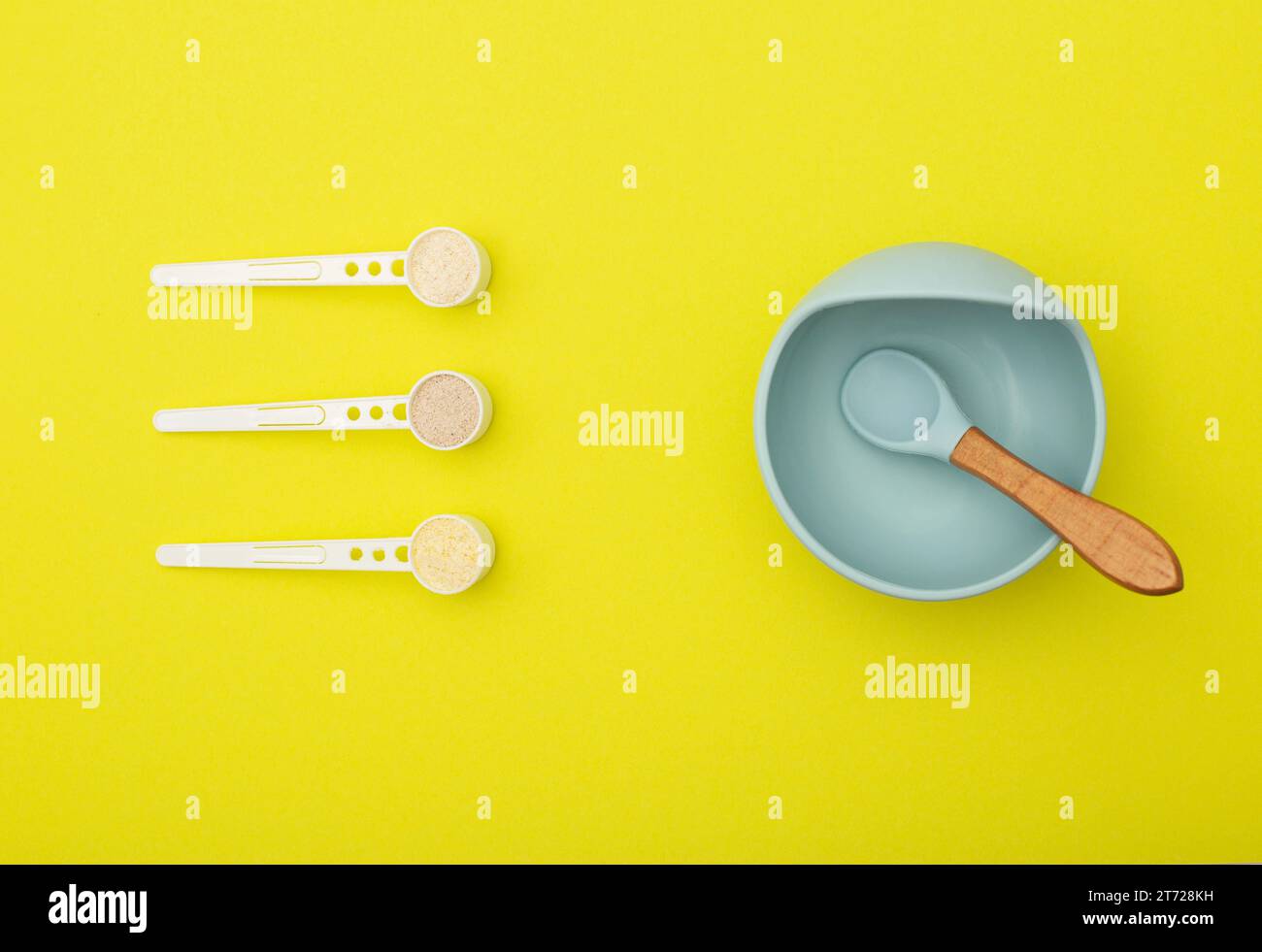 A blue children's plate with a spoon and a set of different dairy-free cereals for children's first feeding. Vitamin-mineral cereals for children, glu Stock Photo