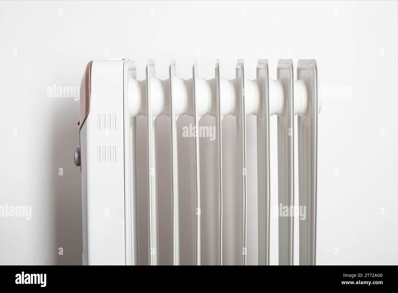 Modern electric oil heater on a white background. Heating the room