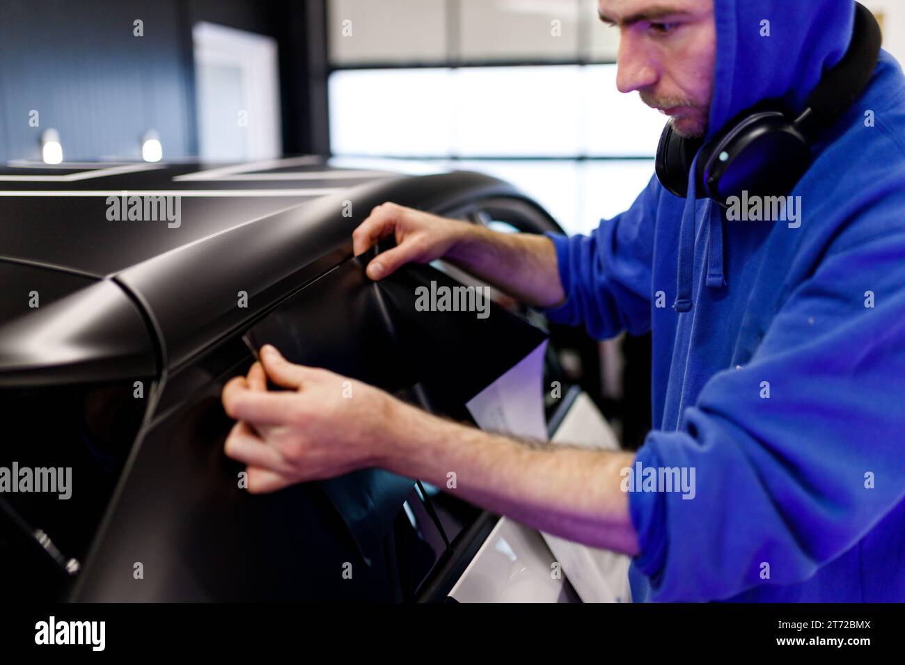 Male hand with spray, car window tint installation process, installing  procedure, tinting film Stock Photo - Alamy