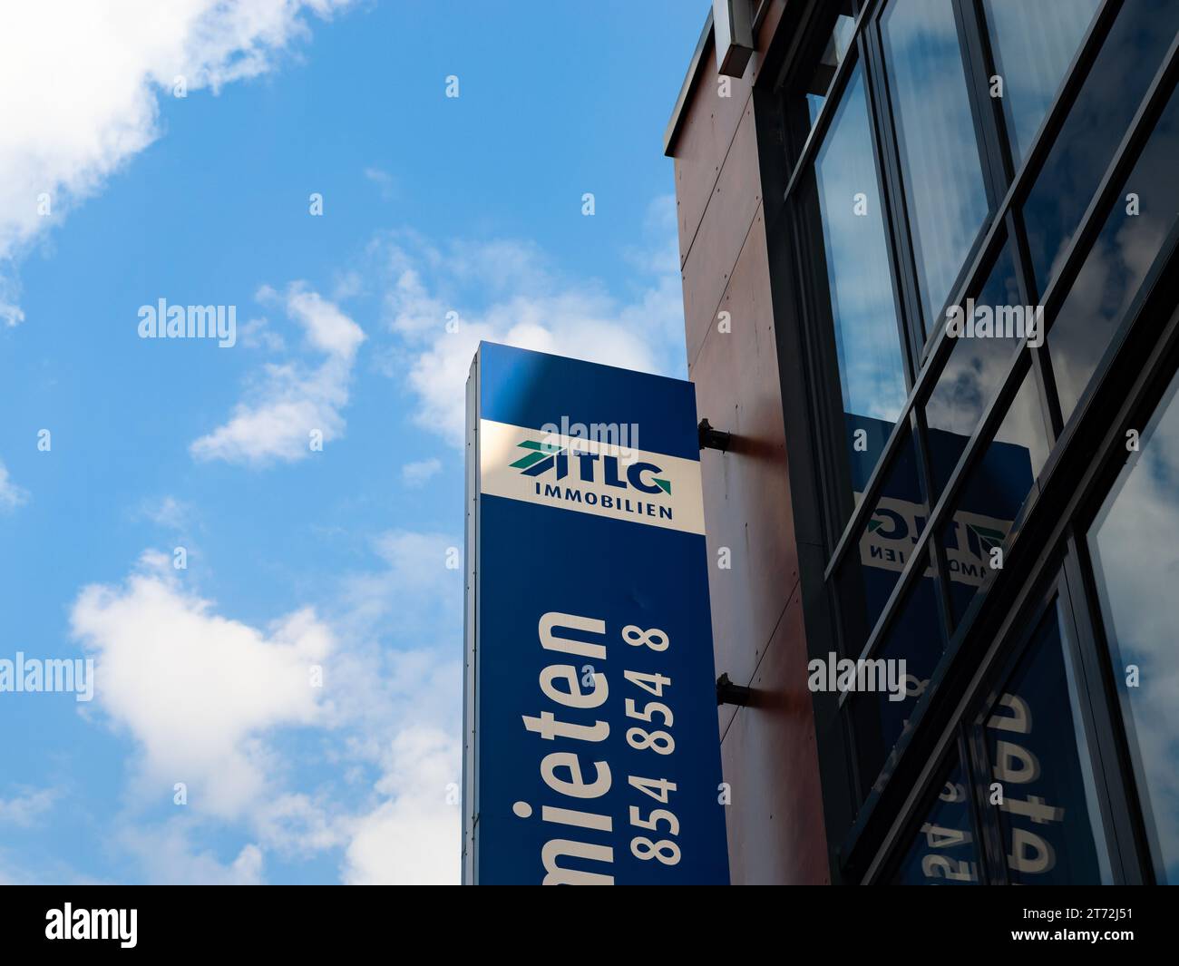 TLG Immobilien logo sign on a building exterior. The commercial lessor is offering business spaces in many German cities. Real estate business. Stock Photo