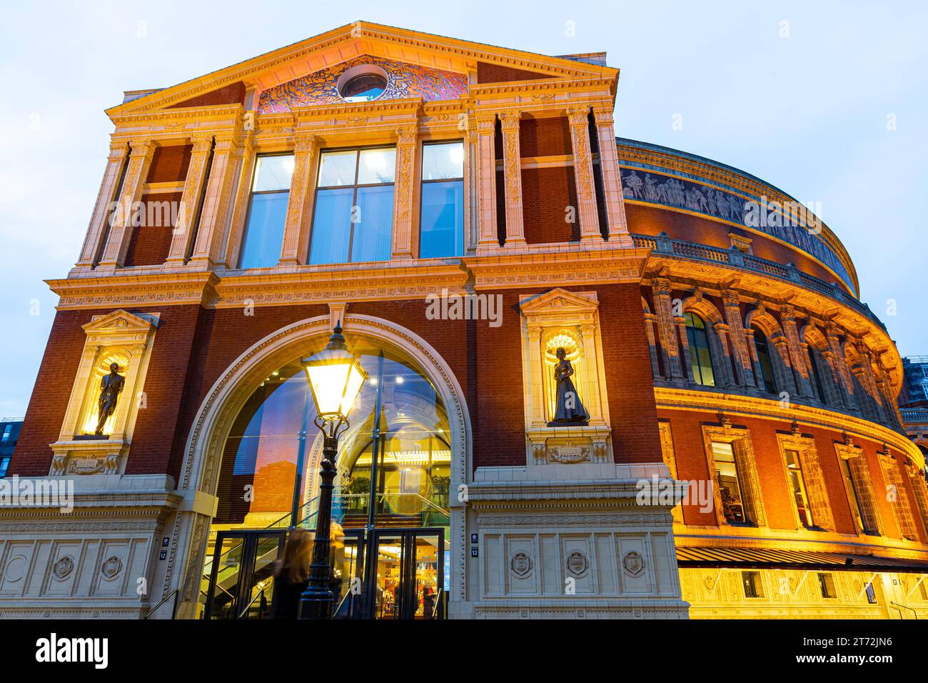 Twilight view of new bronze statues of Elizabeth II and Prince Philip at the Royal Albert Hall in London, UK Stock Photo