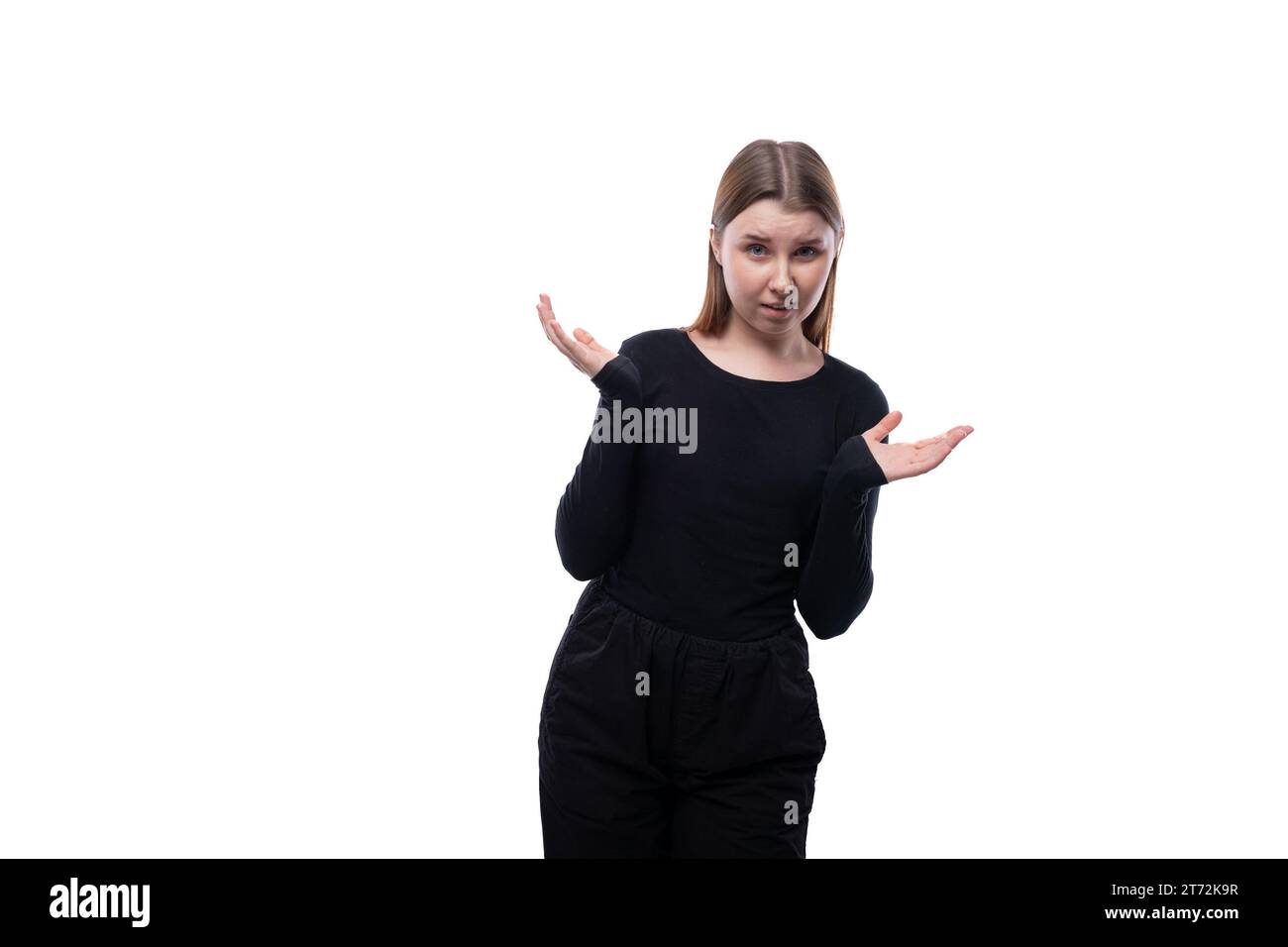 Schoolgirl throws up her hands in surprise on a white background Stock Photo Alamy