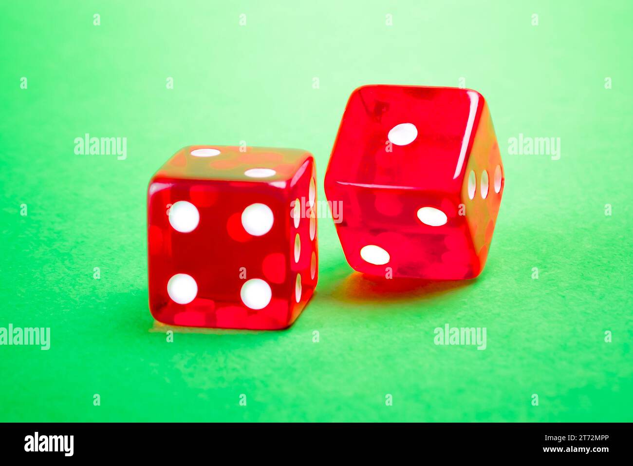 two red dices on green background Stock Photo