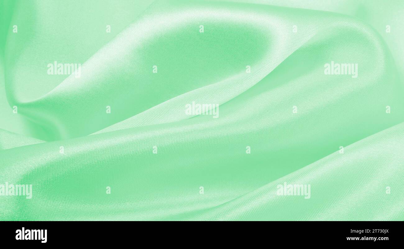 Smooth elegant green silk or satin luxury cloth texture can use as ...