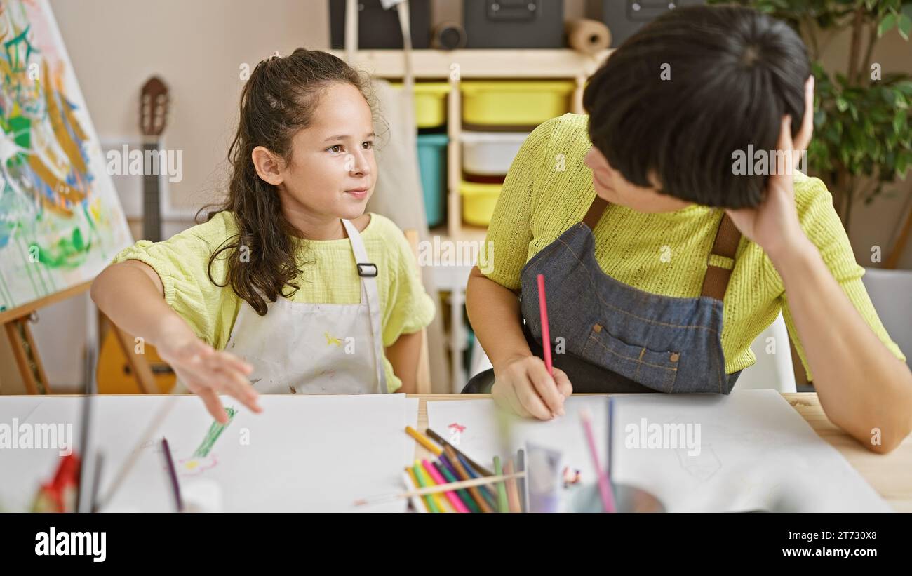 Artistic bonding, teacher and student together draw, speaking ...