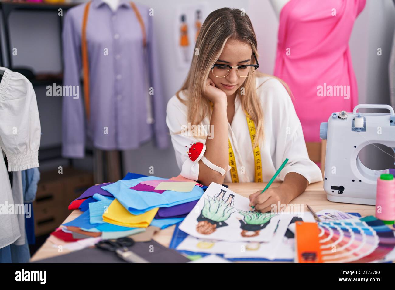 Blonde fashion designer drawing clothes hi-res stock photography and ...