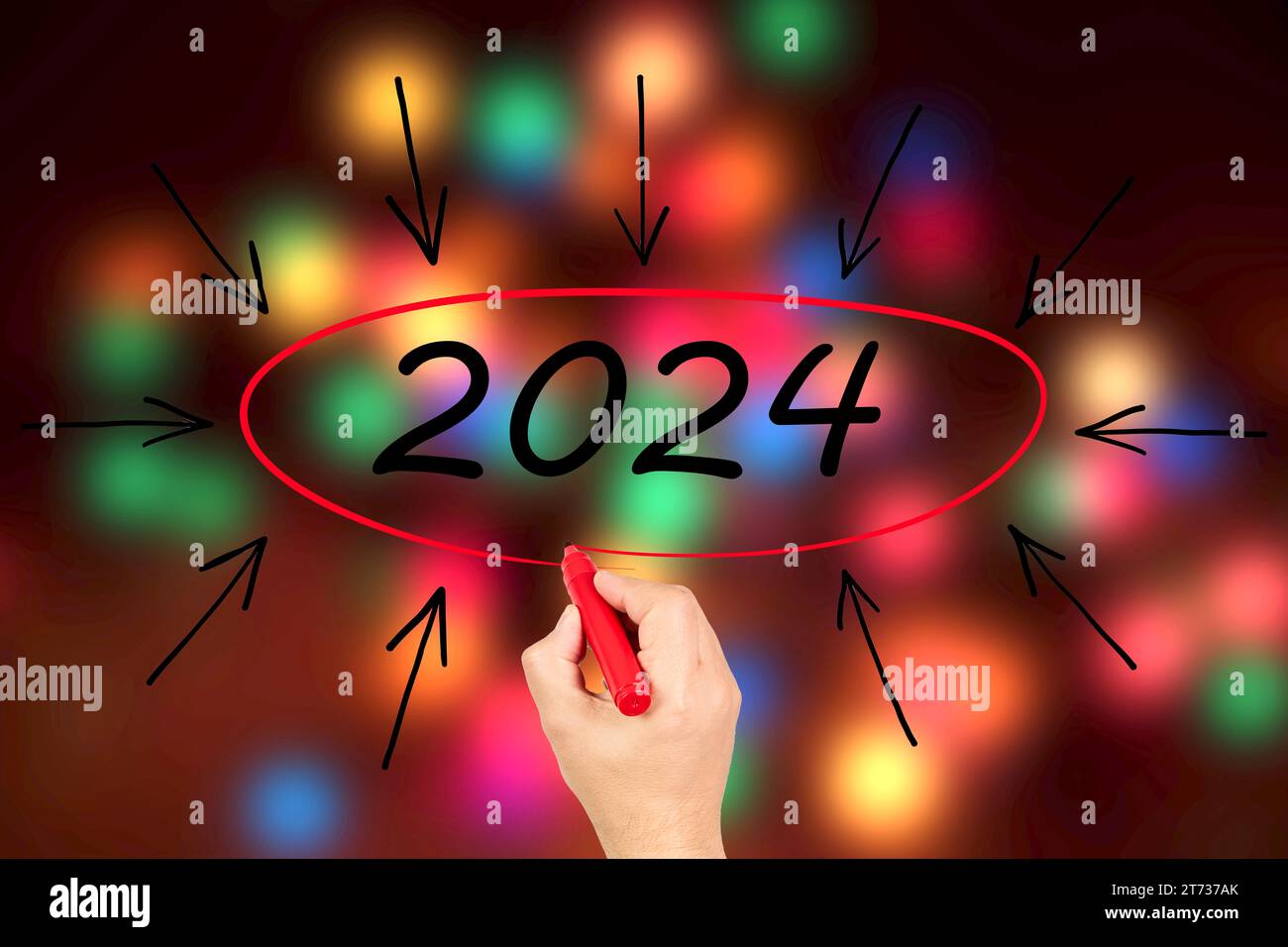 2024, Woman writing the number 2024 on background of faded lights