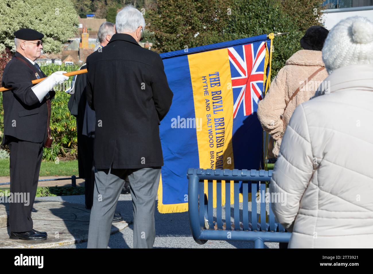 A Royal British Legion standard bearer at a war memorial on the