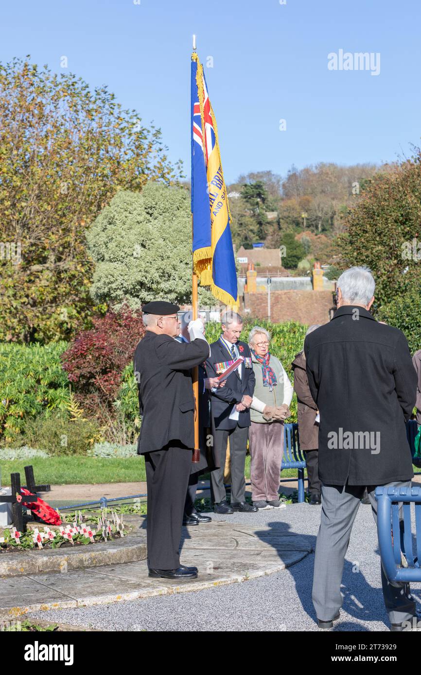 A Royal British Legion standard bearer at a war memorial on the