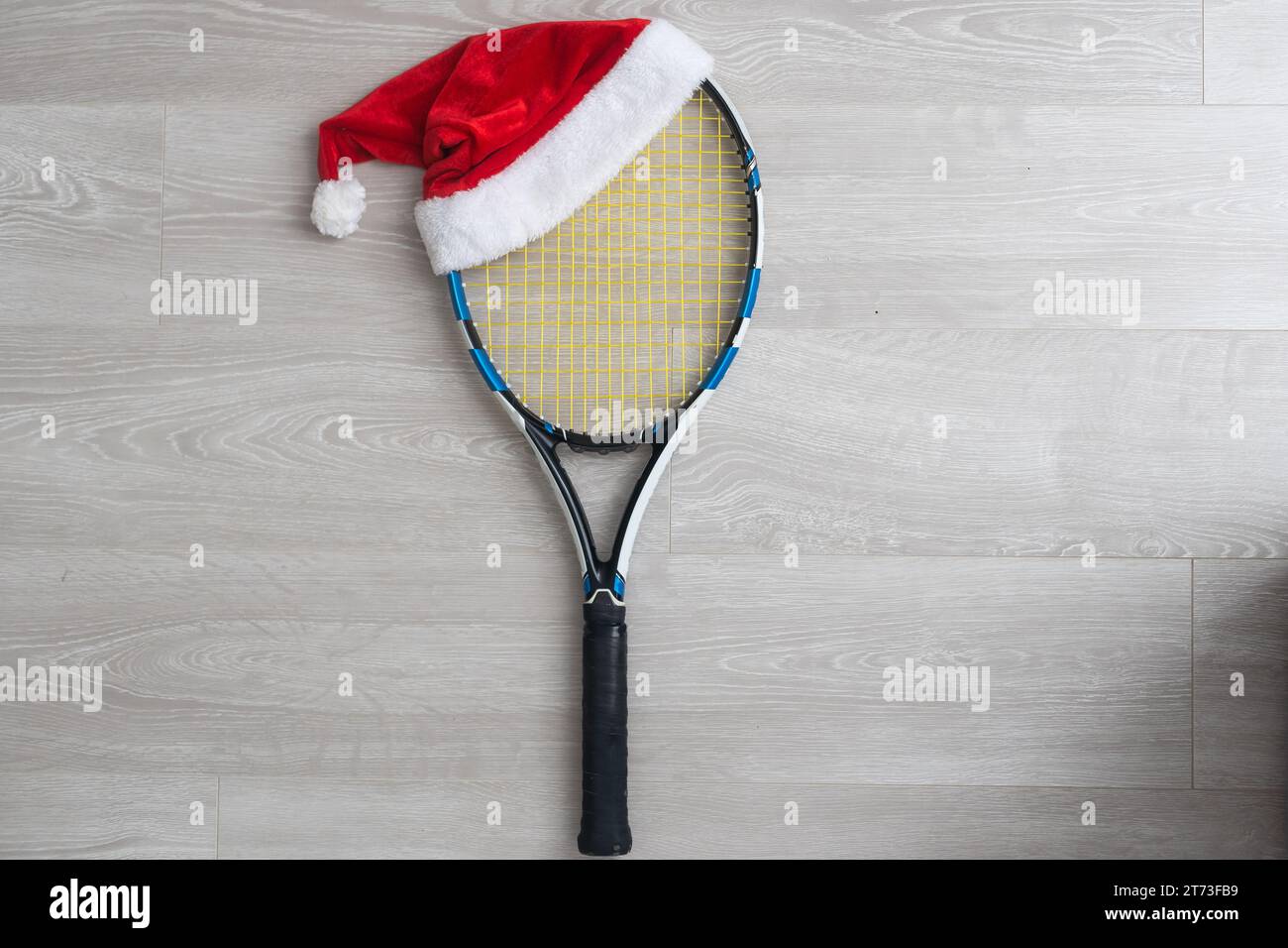 santa hat on tennis rackets on white background Stock Photo Alamy