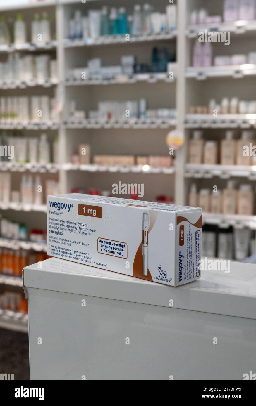 Packaging box of Wegovy (semaglutide) injectable prescription medication, weight-loss drug from Novo Nordisk AS. Pharmacy shop shelves in background. Stock Photo