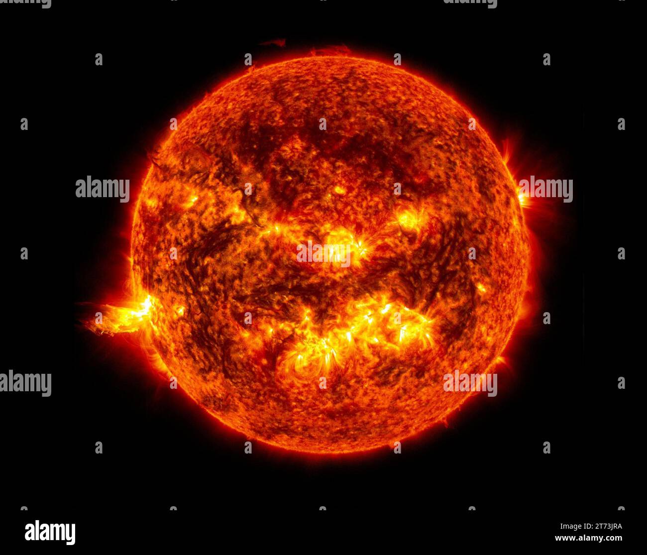 This image from June 20, 2013, at 11:15 p.m. EDT shows the bright light of a solar flare on the left side of the sun and an eruption of solar material Stock Photo