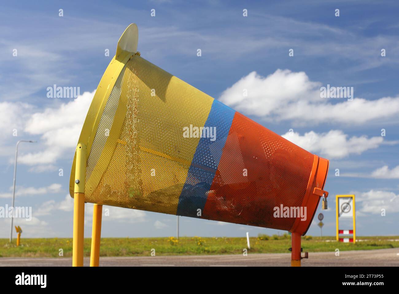 a colourful rubbish containers for cyclists, with blue sky in the background Stock Photo