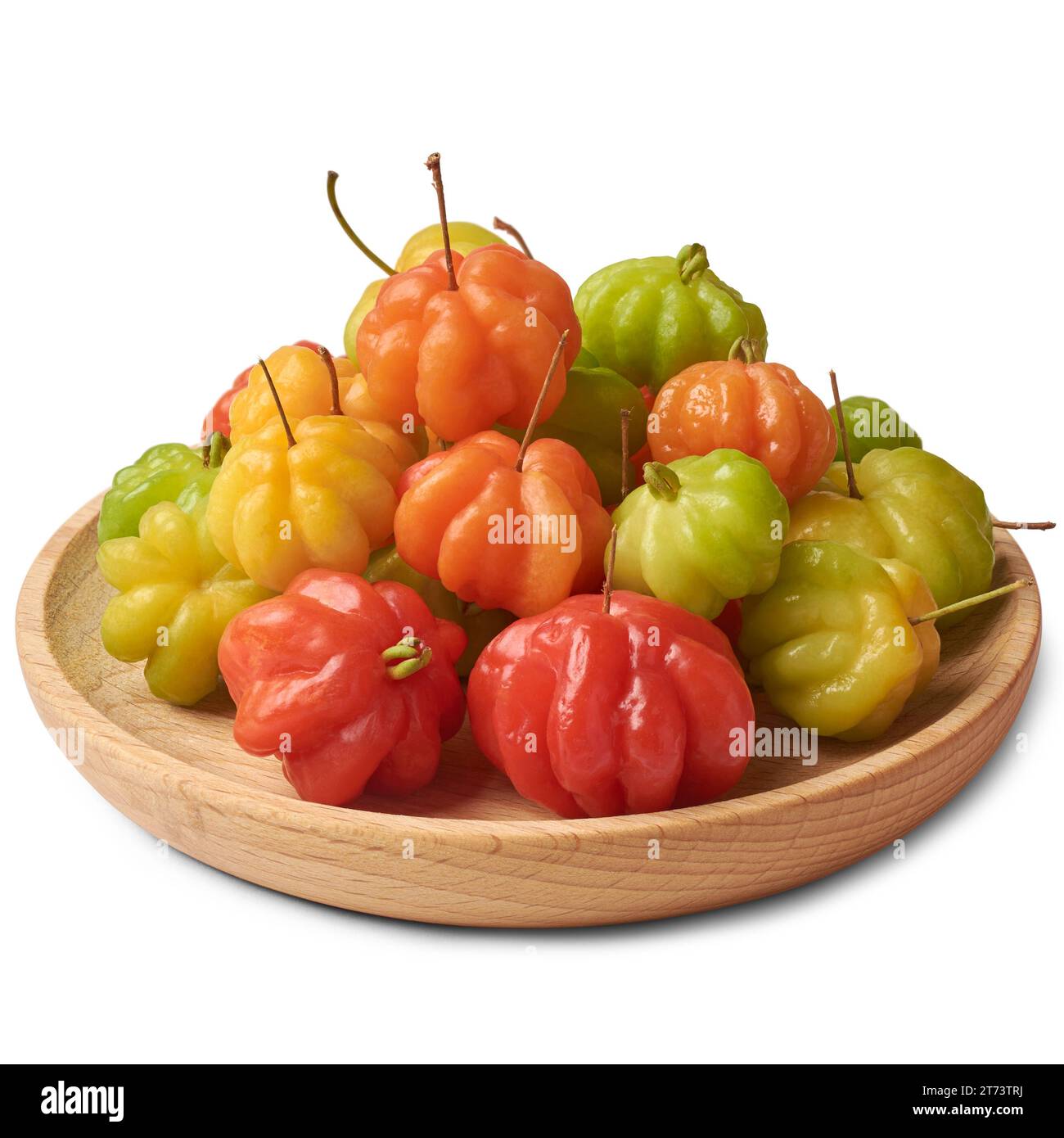 close-up of surinam cherries, eugenia uniflora, aka pitanga, brazilian or cayenne cherry, vibrant colorful fruits on wooden plate, isolated on white Stock Photo