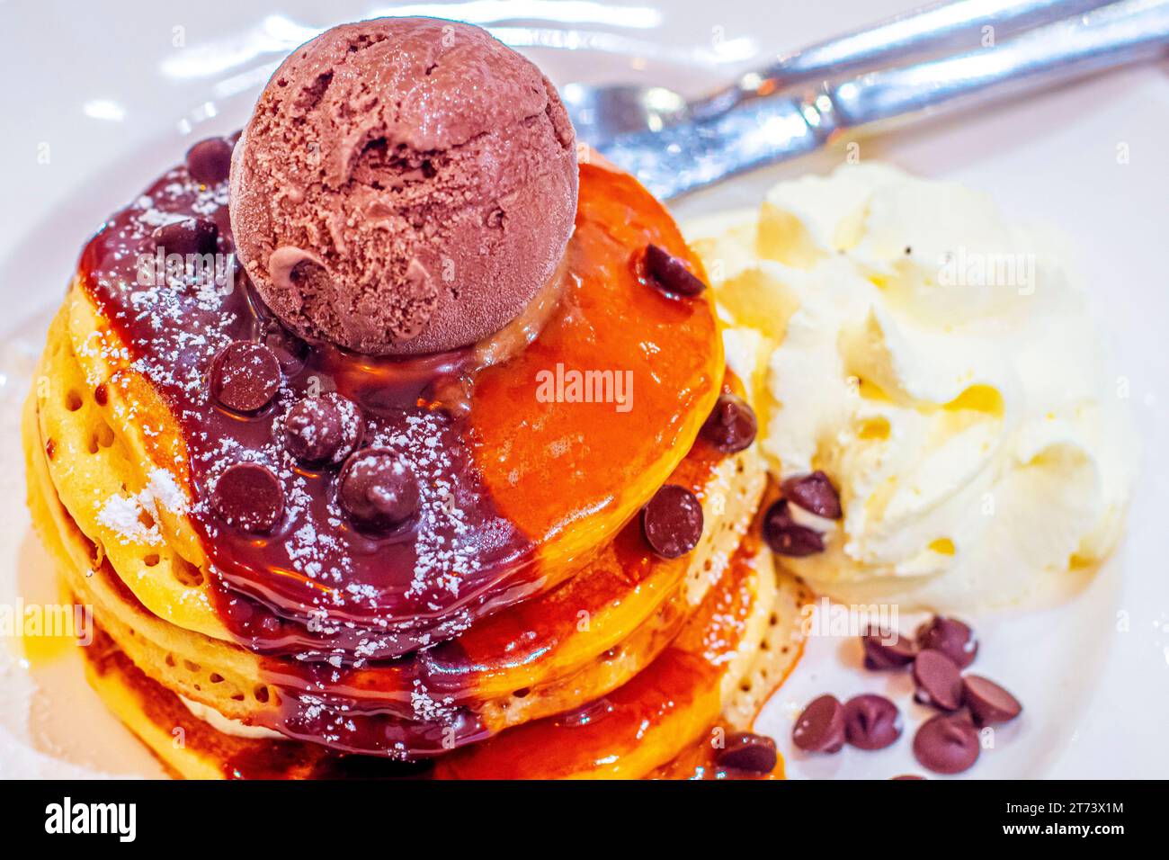 Decadent Delights: Indulging in Chocolate-Kahlua Pancakes with Espresso Mascarpone and Premium Chocolate Ice Cream Stock Photo