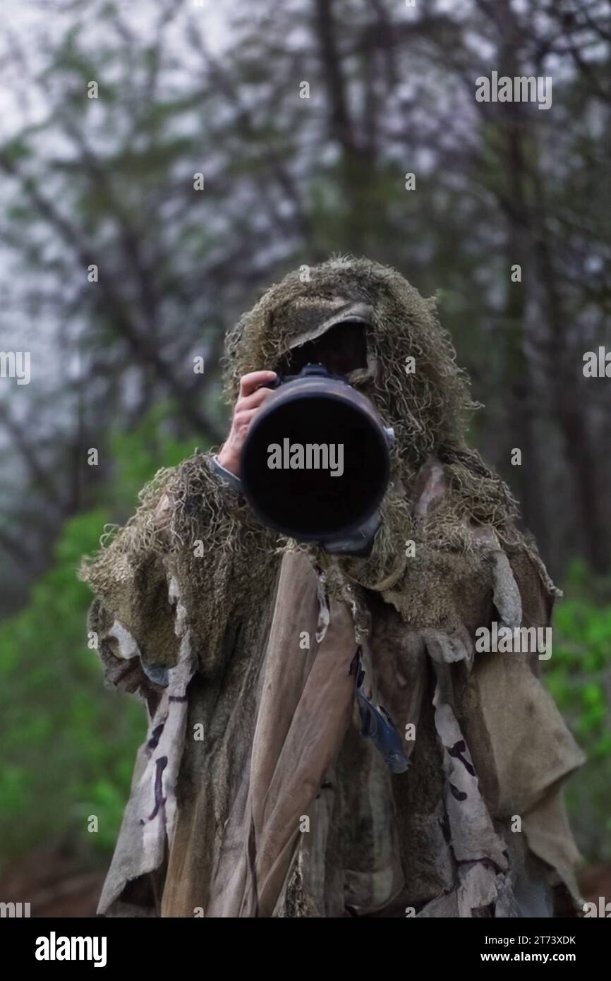 Photographer with camouflage Stock Photo - Alamy