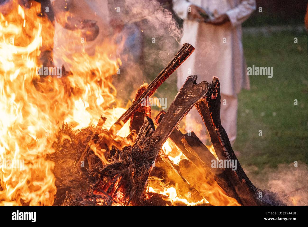 Fire burning with wood sticking out showing funeral pyre in Hindu