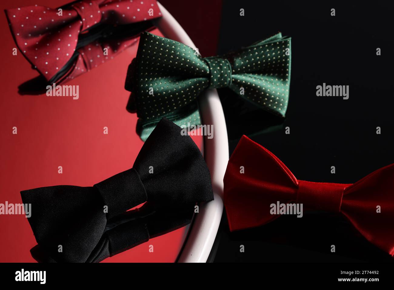 Different stylish bow ties on color background Stock Photo