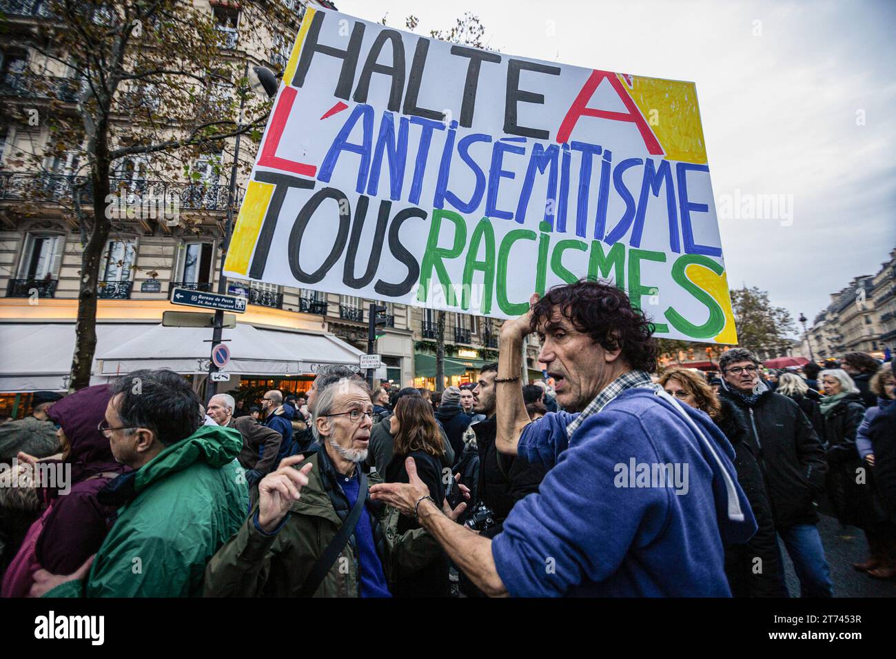 A protester holds a placard that says 'Stop the antisemitism and all the racism' at the end of the demonstration against antisemitism. Demonstrations against antisemitism took place all over France. In Paris, close to 105 thousand people were present at the civic march against anti-Semitism organized by the president of the National Assembly, Yaël Braun-Pivet, and the president of the Senate, Gérard Larcher, together with political parties, with the exception of the La France Soumise party, who refused to participate in the march together with Marine Le Pen's far-right Rassemblement National p Stock Photo