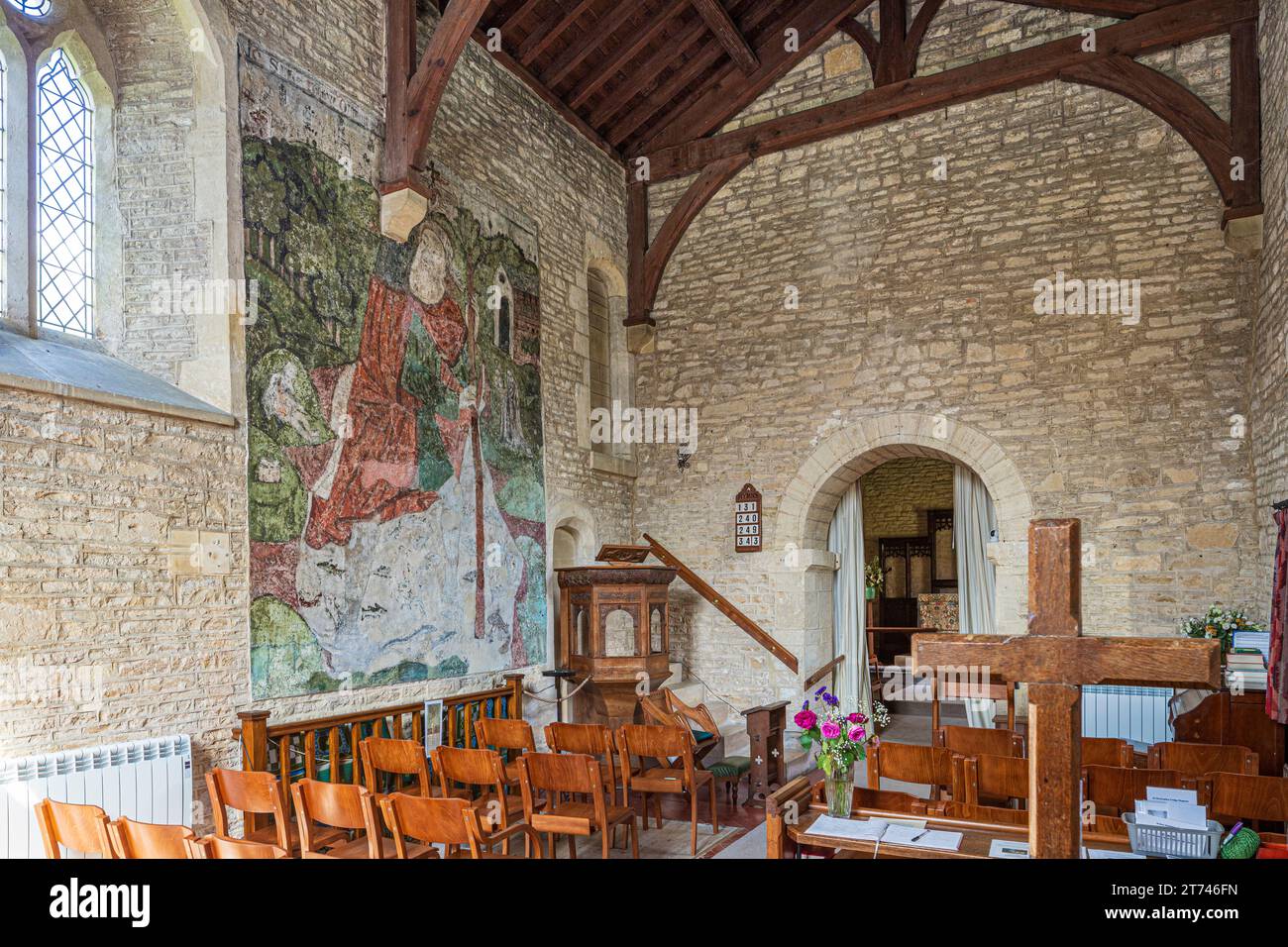 14th century wall painting of St Christopher in the 12th century church of St Mary Magdalene in the Cotswold village of Baunton, Gloucestershire UK Stock Photo
